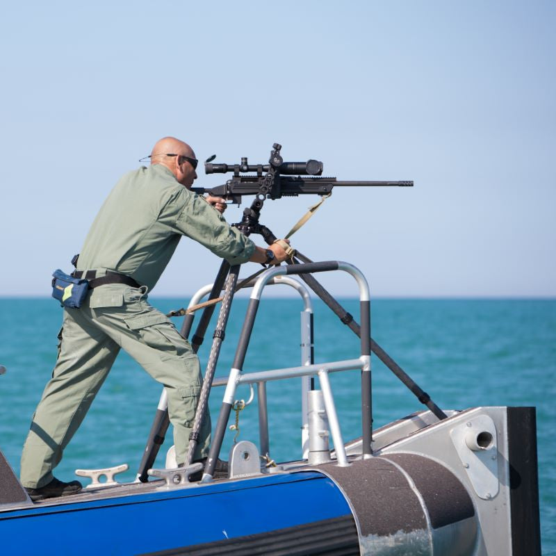 Grom Defense Tripod on a boat with rifle mounted