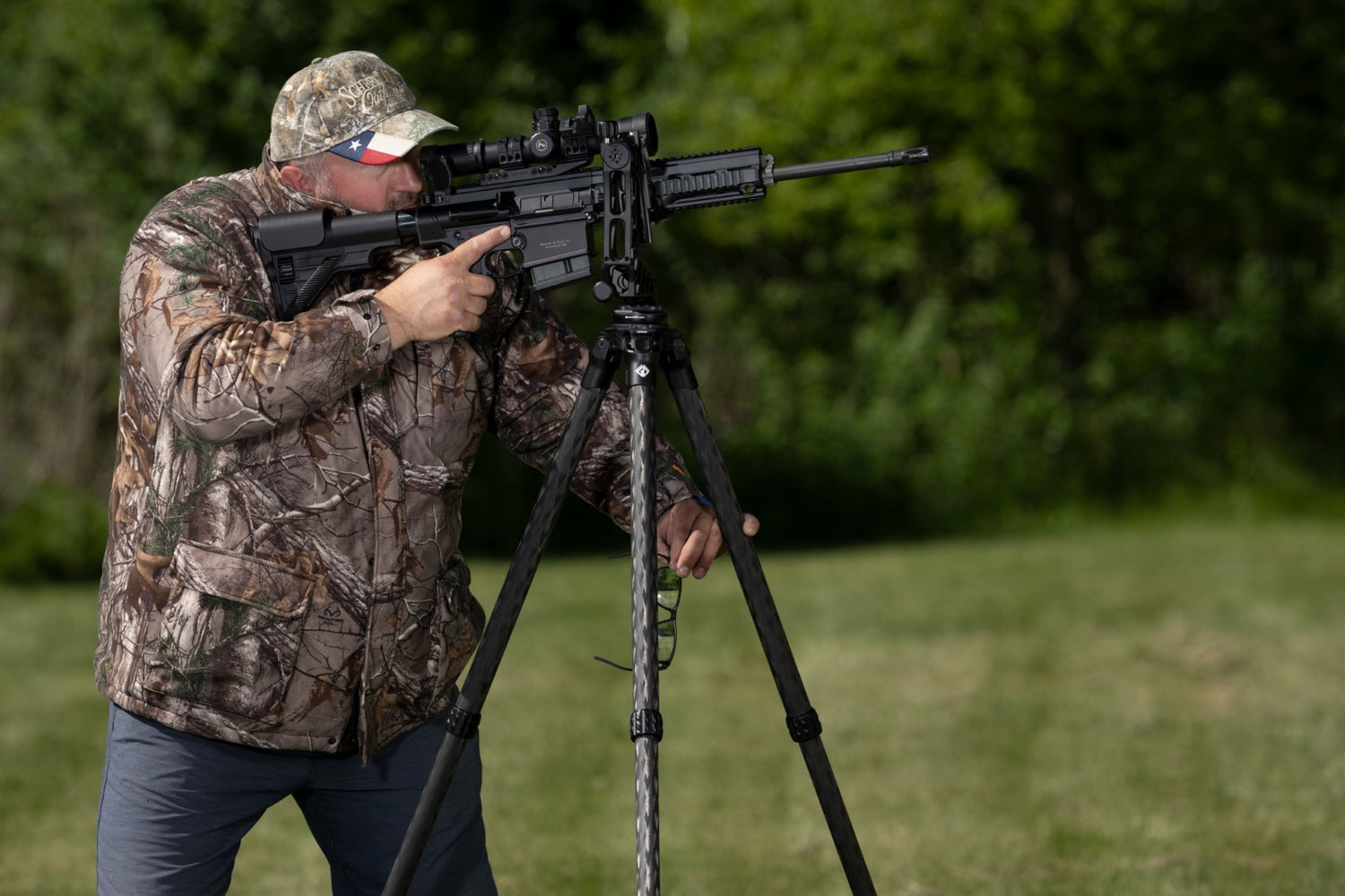 Man shooting rifle with Grom Defense Tripod